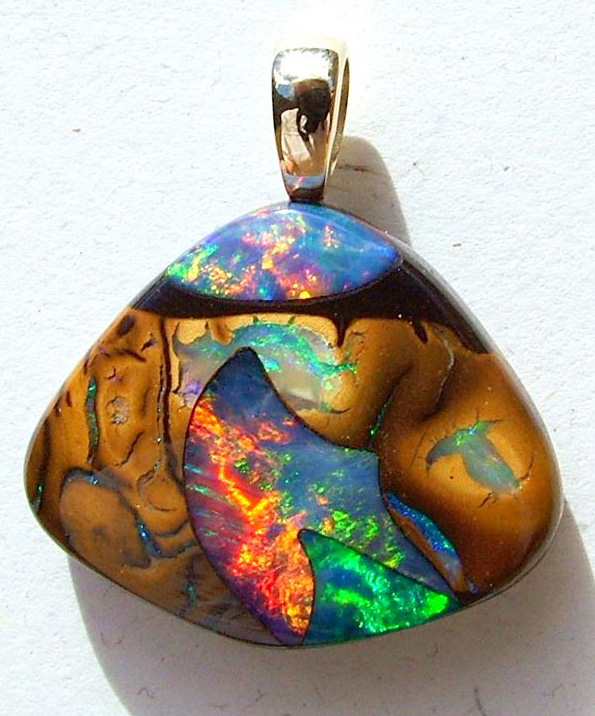 A stunning Koroit Boulder Inlay Gem Opal Pendant of brilliant fire and color.