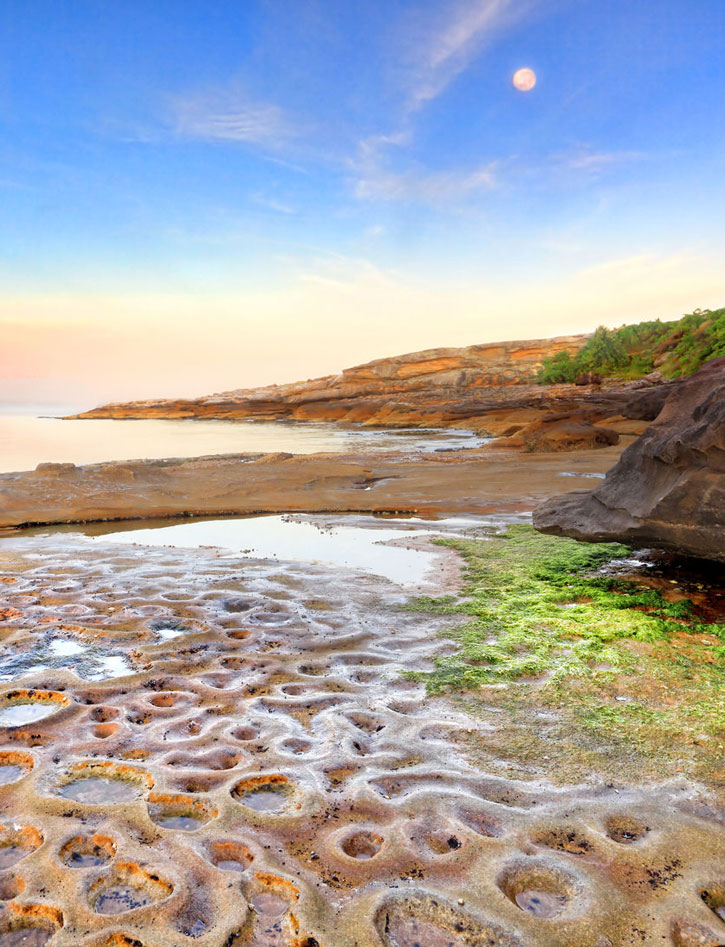 Pock-marked stone shore at La Perouse, Sydney, New South Wales, Australia.