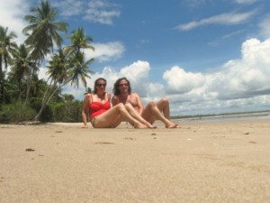 Two people sitting on a beach