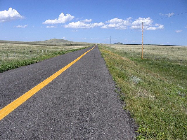 An idyllic two-lane road in New Mexico crossing the Johnson Mesa.