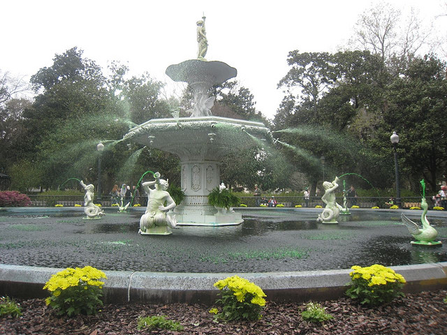 Green-tinted water cascades from the spouts in the Forsyth Park fountain.