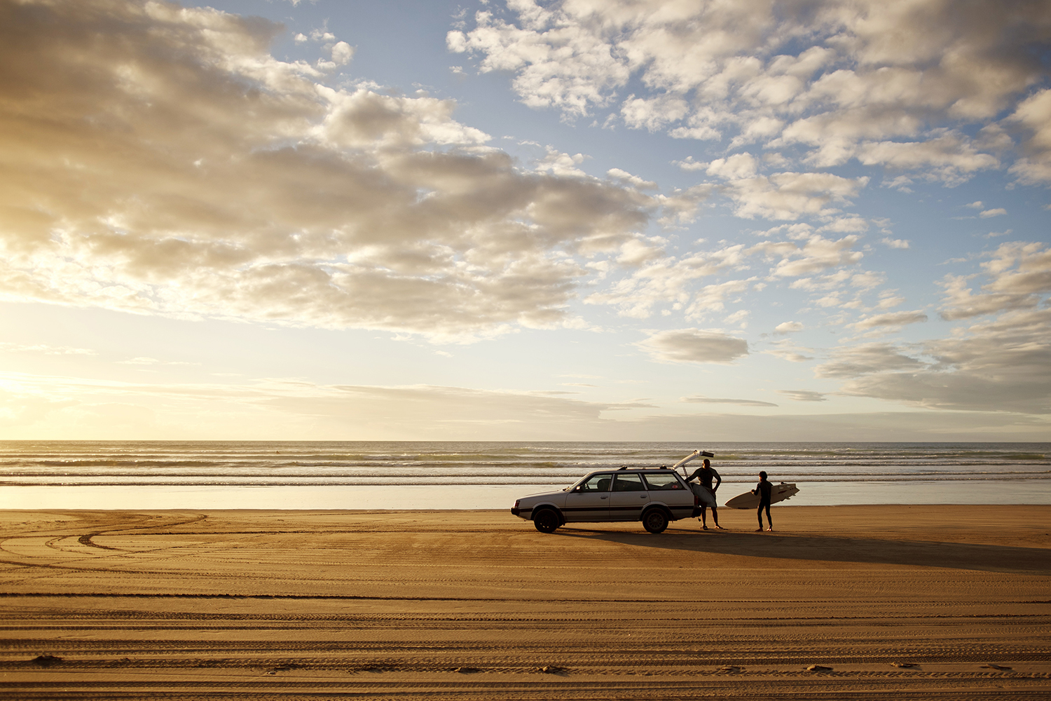 Golden sands and rolling surf make New Zealand's Ninety Mile Beach an irresistible spot to surf until sundown. Image by Amos Chapple / Lonely Planet Images / Getty Images