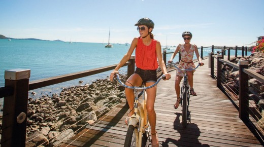 Biking along the Airlie Beach boardwalk, which skirts the Coral Sea from Cannonvale to Airlie Beach.