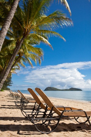 Sun lounges on the beach at Palm Cove, Cairns, Queensland, Australia.