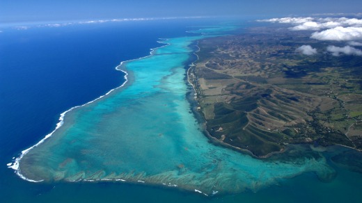 View from the top: Turquoise lagoon with saltwater channels and white sandy beach.