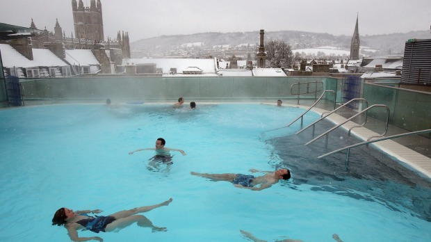 Bathers enjoy the rooftop pool at the Thermae Bath Spa.