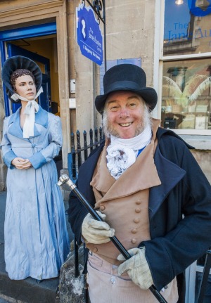 A Museum Greeter in period costume outside the entrance to the Jane Austen Centre in Bath.