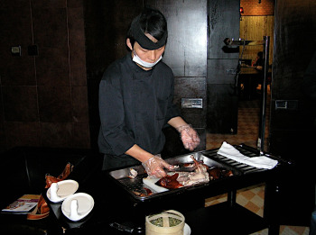 Chef prepares to serve Peking Duck at 1949 The Hidden City