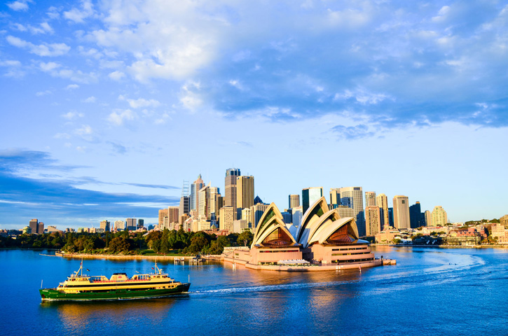 The Manly ferry passes the Sydney Opera House on a bright, sunny day.