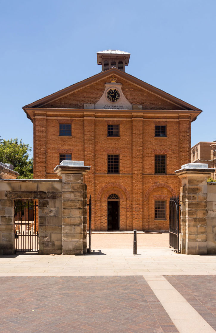The Hyde Park Barracks in Sydney is a three story brick building at the head of Macquarie Street.