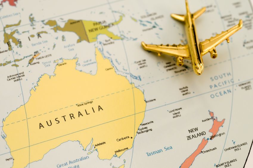 Stock photo of a tiny toy plane resting on a map of Australia.