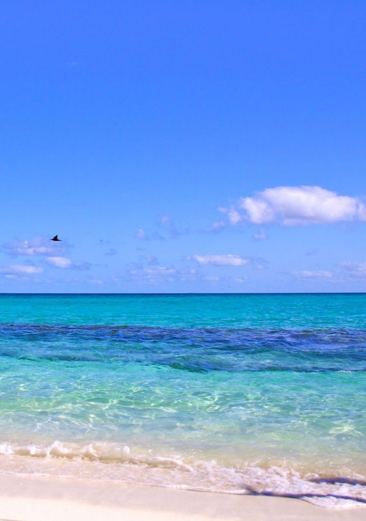 Small waves wash up on shore with incredibly clear water at Heron Island, Australia.