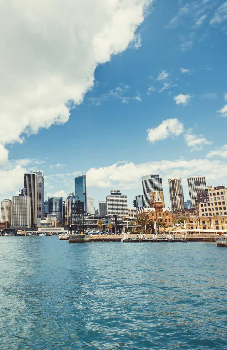 City skyline above Sydney Harbour on a sunny day.