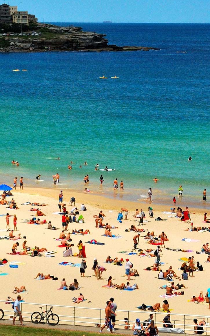 Beachgoers dot the golden sand of Bondi Beach in Sydney, Australia.