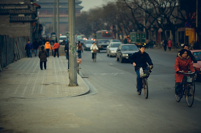 Cyclists and cars share the road in the Houhai area of Beijing.