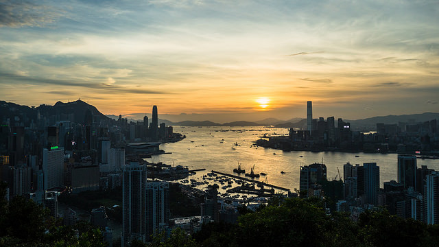 The sun sets on Victoria Harbour leaving Hong Kong in silhouette.