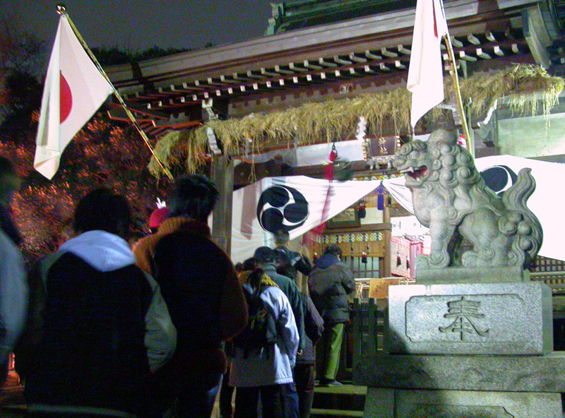 People queue in front of a Shinto shrine to wish for good fortune in the new year.