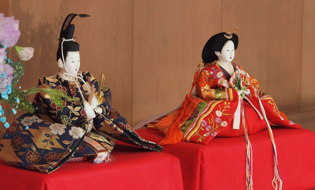 A pair of wooden dolls dressed as emperor and empress of the Heian period.