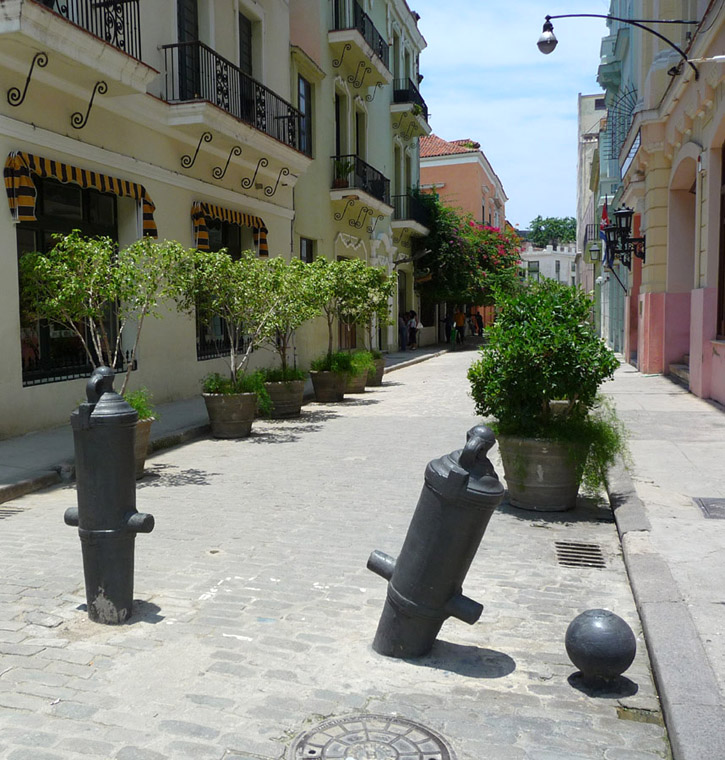 Cannons and cannonballs are used as traffic barricades on Calle Mercaderes in Havana, Cuba.