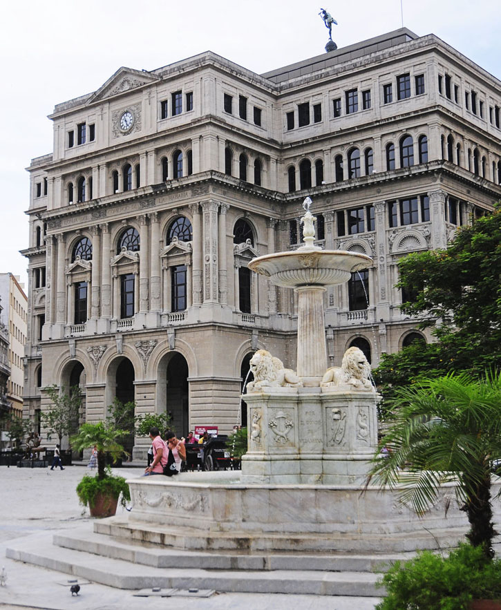 View of Havana's Fuente de los Leones with the Lonja del Comercio in the background.