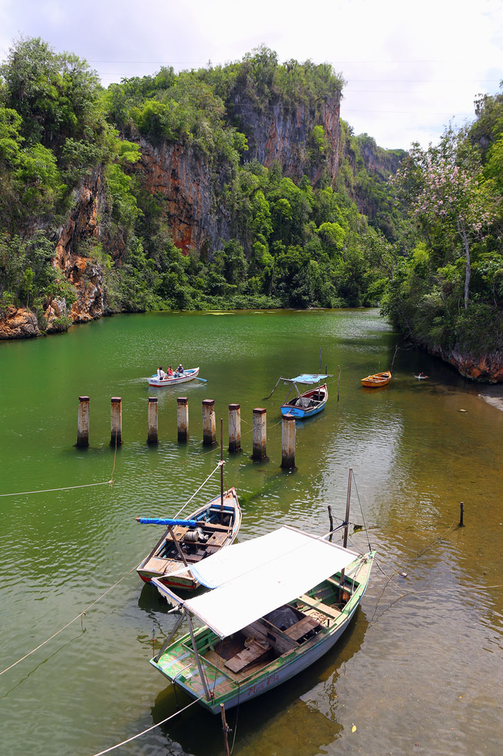 Shaded rowboats in the calm Yumuri River, Guantanamo, Cuba.