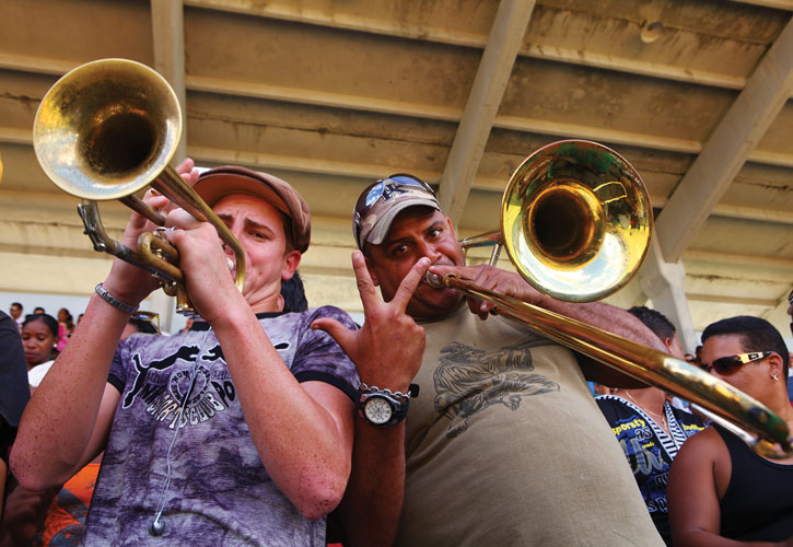 Two jazz musicians playing brass instruments in Cuba.