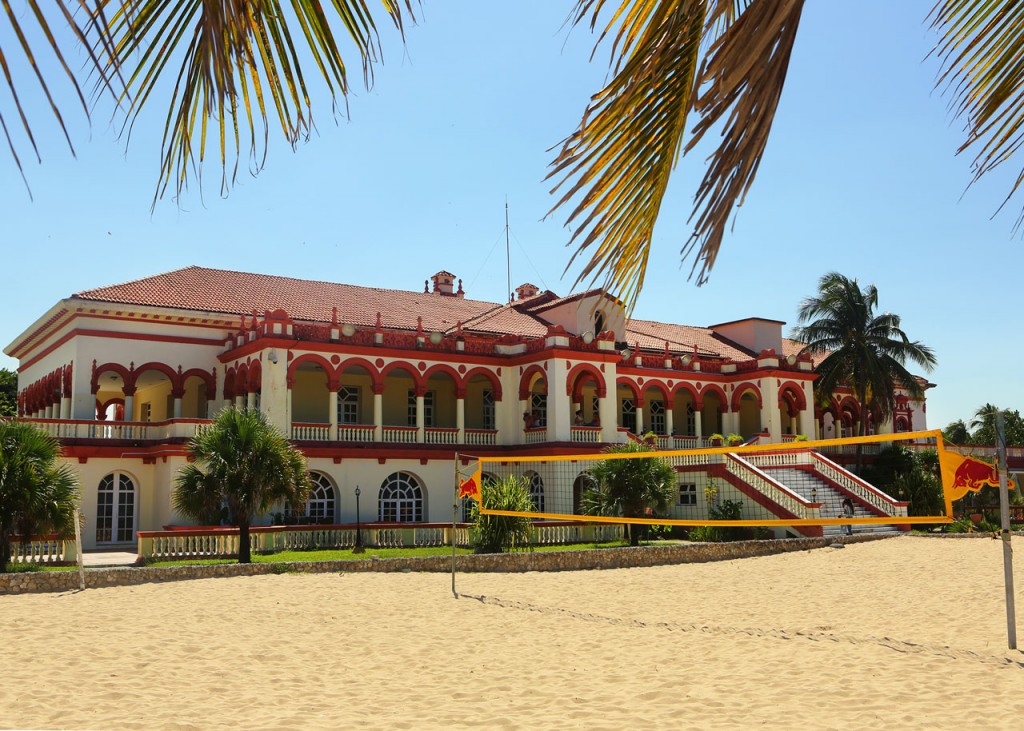 The exclusive Club Habana, a two-story colonial building with a volleyball net in the sand.