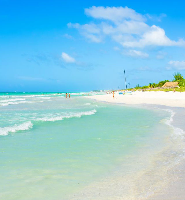 Turqoise water laps against a white sand beach at Varadero, Cuba.