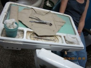 A chairside dental tray has implements resting in grime and dust.