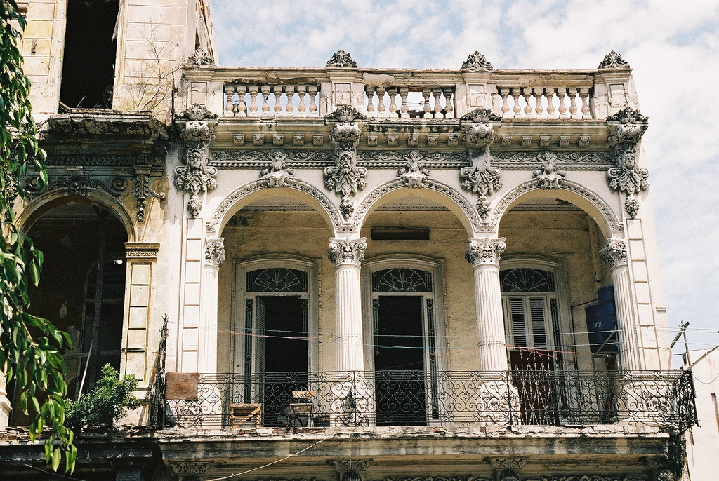 An elaborate colonial style balcony with sculpted pillars.