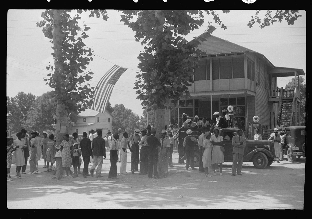 A black and white photograph of a group of African Americans celebrating at a Fourth of July picnic.