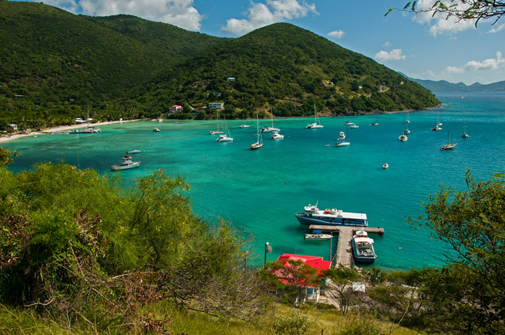 Sailboats rest at anchor in the turquoise waters of Jost Van Dyke's Great Harbour.