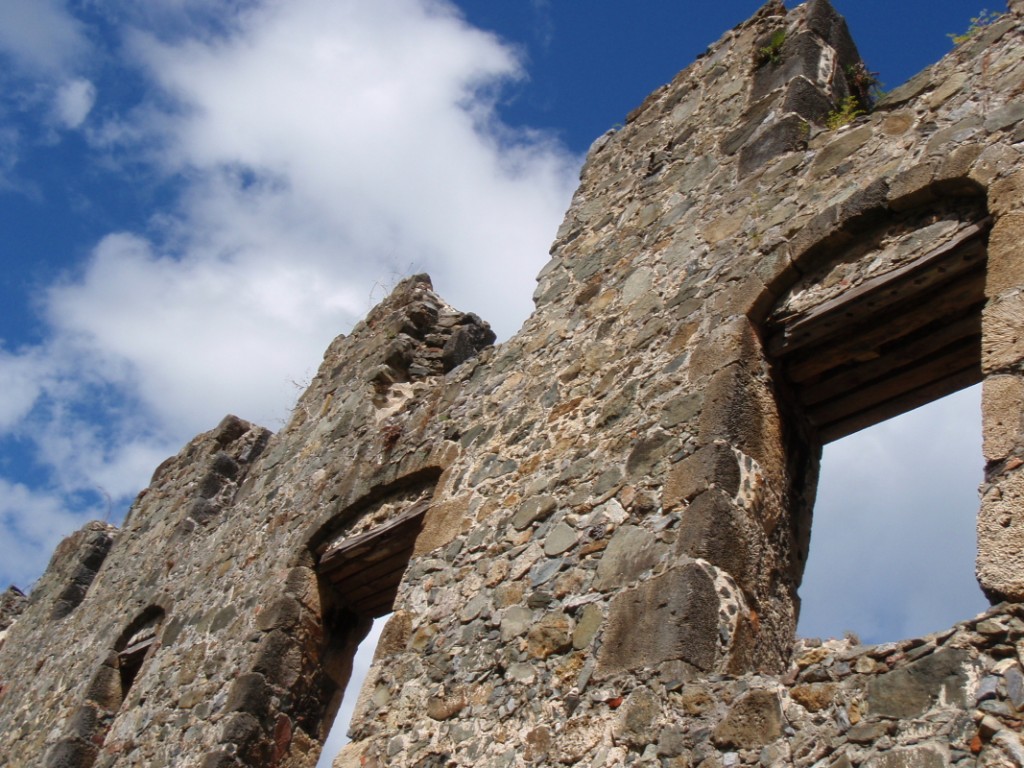 View of a stone wall left standing free with arched windows.