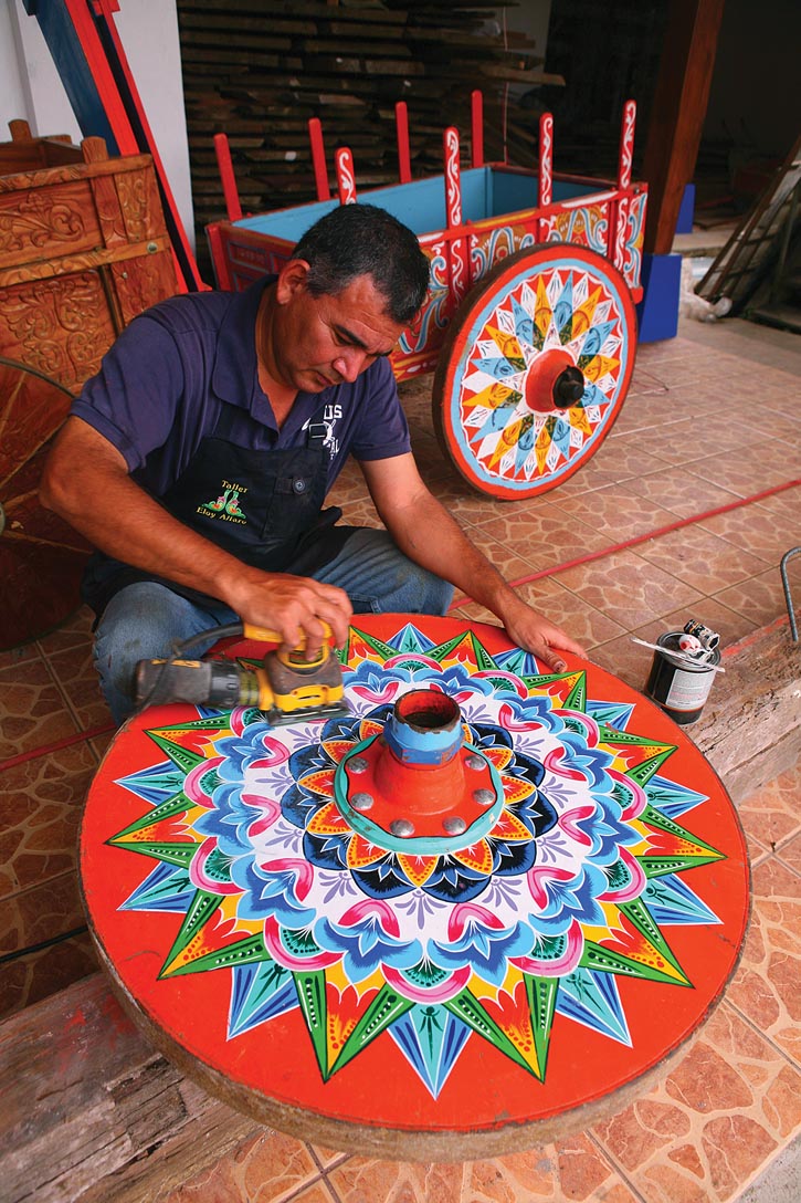 An artisan working on an oxcart wheel.