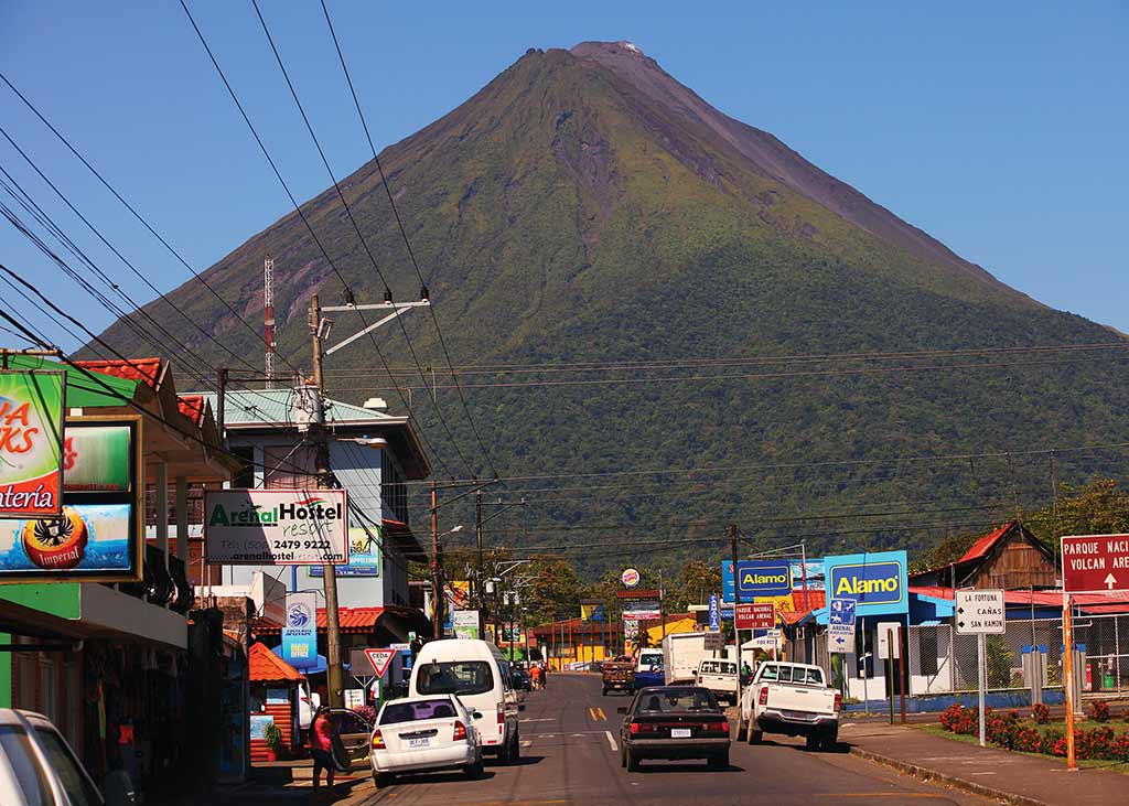 Main street in La Fortuna with Arenal Volcano in the distance. Photo © Christopher P. Baker.