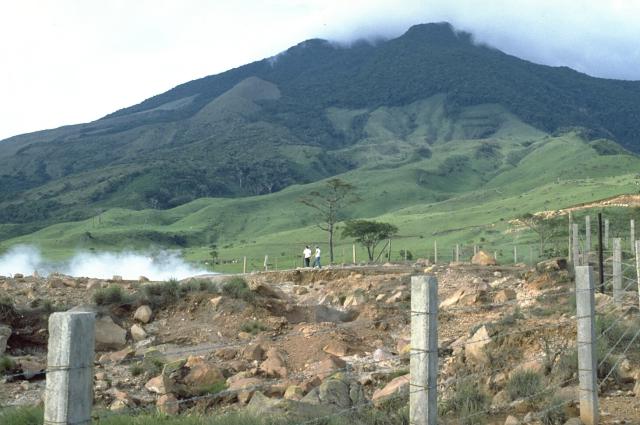 Miravalles volcano rises above a thermal area on its SW flank. Photo © William Melson (Smithsonian Institution) [Public domain], <a href="https://commons.wikimedia.org/wiki/File%3AMiravalles_volcano.jpg">via Wikimedia Commons</a>.