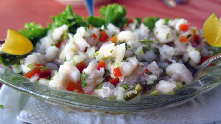 A dish of ceviche rests on a table.