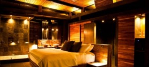 A luxurious looking hotel room lit with warm, golden lights.