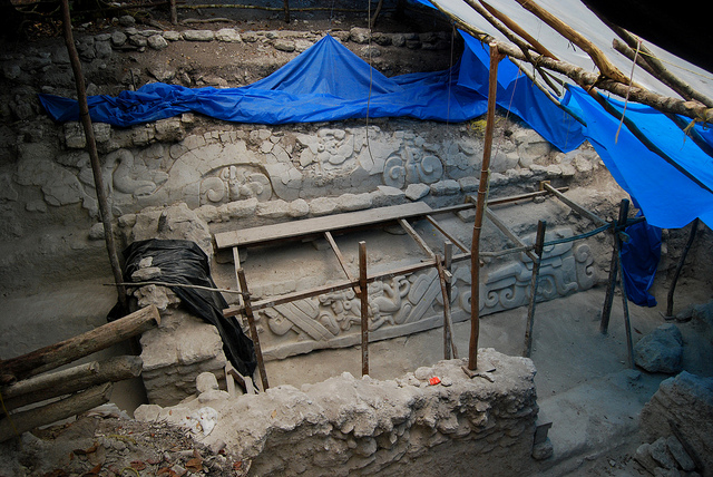 Framework surrounds a well-preserved carved wall that is slowly being unearthed.