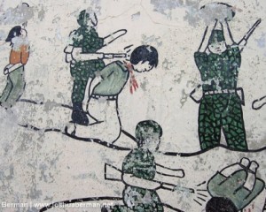 A mural with simplistic figures being brutalized by soldiers.