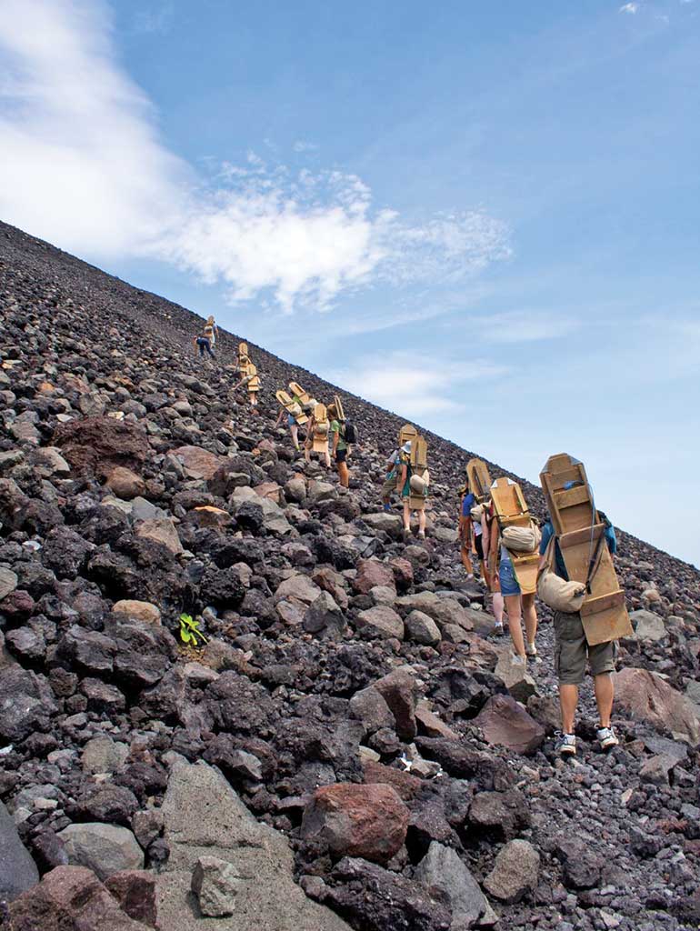 A group of volcano boarders climbing up Cerro Negro. Photo © Ryan Faas/123rf.