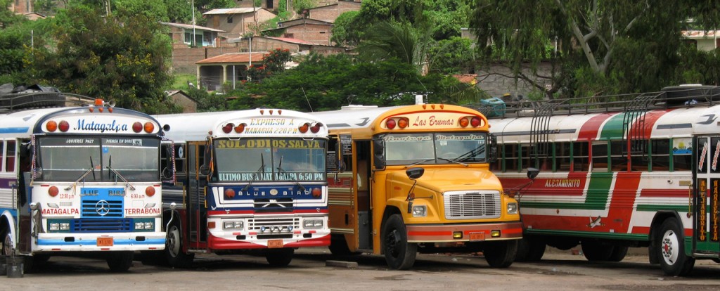 A row of colorful buses waiting at the station in Rivas.