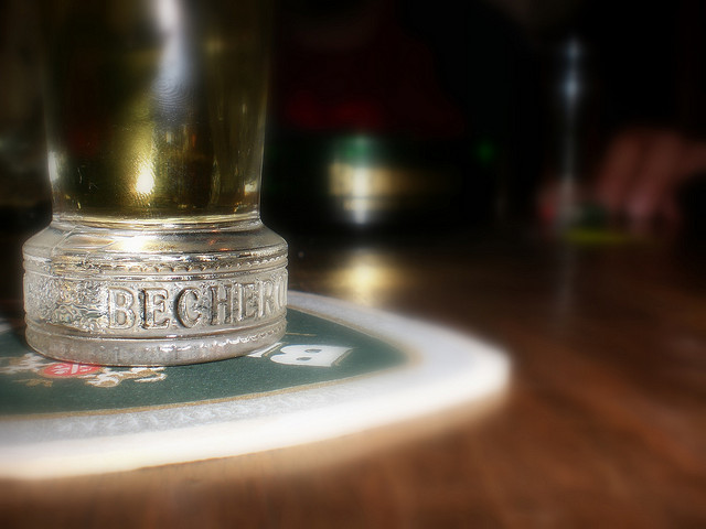 Close up of a Becherovka glass sitting on a coaster.