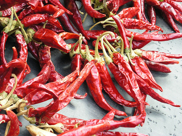 A scatter of bright red paprika peppers.