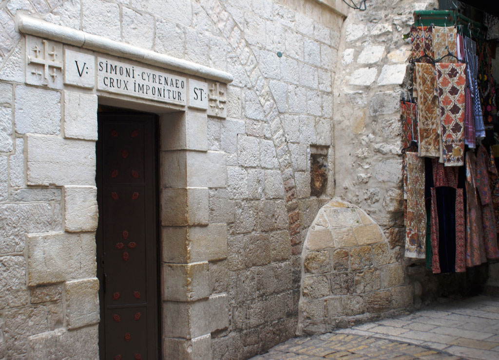 Next to the entrance of a church a square of stone stands out from the rest with a handprint shaped impression.