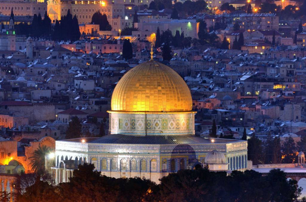 The golden dome of the Dome of the Rock stands out in sharp contrast to the cluster of smaller buildings in Old City.