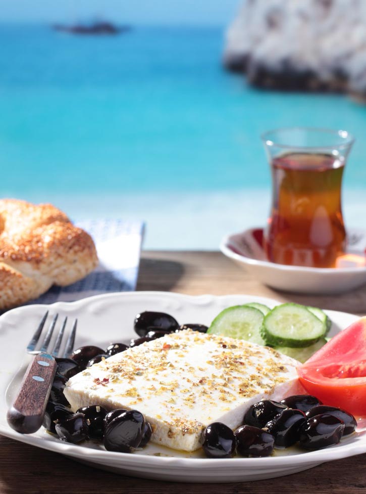 A turkish breakfast of feta, olives, cucumber, and tomato on the shores of the Mediterranean.