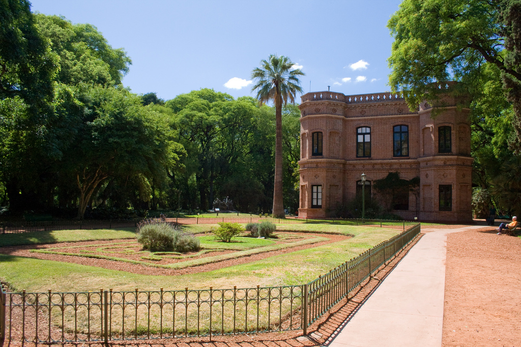 Neat paths surrounded a landscaped patch of grass framed by trees.