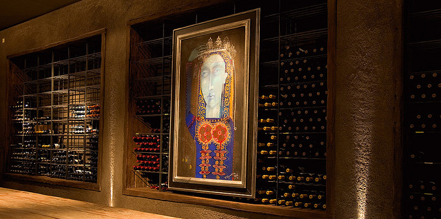 A painting hangs amongst a cellar wine room at O. Fournier in Argentina.