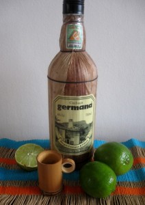 Bottle of cachaca and limes